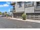 Modern three-story building featuring two garage doors and multiple windows and balconies at 2090 S Dorsey Ln # 1037, Tempe, AZ 85282