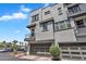 Exterior shot showcasing modern townhouse with garage, multiple balconies and manicured landscaping at 2090 S Dorsey Ln # 1037, Tempe, AZ 85282