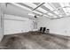 Spacious garage featuring overhead racks, fluorescent lighting, and a water heater at 2090 S Dorsey Ln # 1037, Tempe, AZ 85282