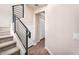 Stairway features carpet on the steps and metal railing leading to a hallway with wood floors and white trim at 2090 S Dorsey Ln # 1037, Tempe, AZ 85282