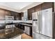 Modern kitchen featuring dark cabinets, granite countertops, stainless steel appliances, and an island at 2090 S Dorsey Ln # 1037, Tempe, AZ 85282