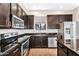 Gourmet kitchen with stainless steel appliances, dark cabinetry, granite countertops, and a central island at 2090 S Dorsey Ln # 1037, Tempe, AZ 85282
