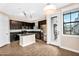 Beautiful kitchen with dark cabinets, stainless steel appliances, a kitchen island, and stylish lighting at 2090 S Dorsey Ln # 1037, Tempe, AZ 85282