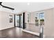 View of a spacious living room with wood floors, black metal railing, and sliding doors leading to balcony at 2090 S Dorsey Ln # 1037, Tempe, AZ 85282