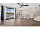 Bright living space featuring wood floors, large windows with outdoor views, and a modern ceiling fan at 2090 S Dorsey Ln # 1037, Tempe, AZ 85282