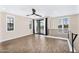 View of the light-filled living room with hardwood floors and sliding doors to a balcony with neighborhood views at 2090 S Dorsey Ln # 1037, Tempe, AZ 85282