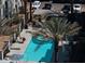 Inviting community pool and lounge area with mature palms and outdoor grill at 2090 S Dorsey Ln # 1037, Tempe, AZ 85282