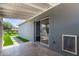 A view of the backyard from under a covered back patio with a sliding glass door at 2325 E Delgado St, Phoenix, AZ 85022