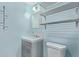 Bathroom featuring blue walls, cabinet and an open metal shelving unit at 2325 E Delgado St, Phoenix, AZ 85022