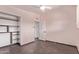 Bedroom with tile flooring, closet shelving, and a window for natural light at 2325 E Delgado St, Phoenix, AZ 85022