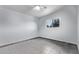 A light blue bedroom with a ceiling fan and a window overlooking the yard at 2325 E Delgado St, Phoenix, AZ 85022