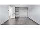 A bedroom with tile floors and open white closet with shelving and a clothing rod at 2325 E Delgado St, Phoenix, AZ 85022