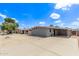 Charming single-story home featuring a large, paved driveway and desert landscaping under a bright, sunny sky at 2325 E Delgado St, Phoenix, AZ 85022