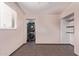 Small room with a window, shelves, and a closet with a stackable washer and dryer at 2325 E Delgado St, Phoenix, AZ 85022