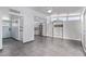Bright, open-concept living room with tiled floors, built-in shelving, and large windows for ample natural light at 2325 E Delgado St, Phoenix, AZ 85022