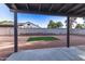 View of backyard with gravel and square of artificial turf as seen from covered patio at 2345 E Isabella Ave, Mesa, AZ 85204