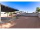 Expansive backyard featuring low-maintenance gravel landscaping, covered patio and small turf square at 2345 E Isabella Ave, Mesa, AZ 85204