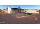 Home exterior features a spacious backyard landscaped with gravel, turf, and a covered patio at 2345 E Isabella Ave, Mesa, AZ 85204