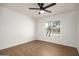 Cozy bedroom featuring wood-look floors, a ceiling fan, and natural light at 2345 E Isabella Ave, Mesa, AZ 85204