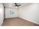 Bright bedroom features a ceiling fan, wood-look flooring, and ample natural light at 2345 E Isabella Ave, Mesa, AZ 85204