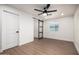 This bedroom features modern design with a barn door and wood-look flooring at 2345 E Isabella Ave, Mesa, AZ 85204