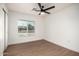 Bright bedroom with wood-look floors and a modern ceiling fan fixture at 2345 E Isabella Ave, Mesa, AZ 85204