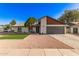 Lovely single-story home featuring a two-car garage, manicured lawn, and gravel landscaping at 2345 E Isabella Ave, Mesa, AZ 85204