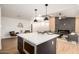 Open kitchen with a center island, modern appliances, and seamless flow to the living area at 2345 E Isabella Ave, Mesa, AZ 85204