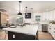 Stylish kitchen featuring white cabinets, a sleek black range hood, and modern stainless steel appliances at 2345 E Isabella Ave, Mesa, AZ 85204