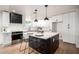 Beautiful kitchen featuring white cabinetry, a center island with seating, and pendant lighting at 2345 E Isabella Ave, Mesa, AZ 85204