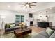 Bright living room featuring modern furnishings, an open layout to the kitchen, and natural light at 2345 E Isabella Ave, Mesa, AZ 85204