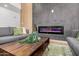 Close up shot of the living room, showcasing the stylish fireplace and wooden coffee table at 2345 E Isabella Ave, Mesa, AZ 85204