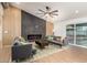 Stylish living room featuring modern sofas, decorative fireplace, wood accent wall, and natural lighting at 2345 E Isabella Ave, Mesa, AZ 85204