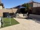 Outdoor entertaining space complete with patio seating, artificial turf, and a shaded cantilever umbrella at 23497 S 212Th St, Queen Creek, AZ 85142