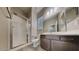 Bright bathroom featuring a glass shower, stylish vanity, and wood-look tile flooring at 23497 S 212Th St, Queen Creek, AZ 85142
