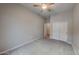 This plush bedroom features neutral carpeting, a ceiling fan, and a large closet with sliding doors at 23497 S 212Th St, Queen Creek, AZ 85142