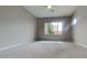 Spacious bedroom featuring neutral-toned carpet, a large window, and a ceiling fan at 23497 S 212Th St, Queen Creek, AZ 85142