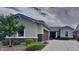 Charming single-story home featuring a well-manicured lawn, mature trees, and an attached two-car garage at 23497 S 212Th St, Queen Creek, AZ 85142