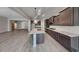 Open concept kitchen features stainless steel appliances, a large island, and dark wood cabinets at 23497 S 212Th St, Queen Creek, AZ 85142