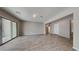 Spacious living room featuring sliding glass doors to the patio and wood look floors at 23497 S 212Th St, Queen Creek, AZ 85142