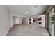 Bright open-concept living room featuring tile floors, recessed lighting, and a sliding door to the patio at 23497 S 212Th St, Queen Creek, AZ 85142