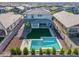 Beautiful aerial view of the property highlighting the pool, covered patio, and manicured backyard in a residential neighborhood at 25725 S 230Th St, Queen Creek, AZ 85142