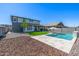 Spacious backyard with a pool, patio area, and low-maintenance landscaping at 25725 S 230Th St, Queen Creek, AZ 85142