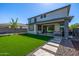 Beautiful backyard with artificial turf, stepping stones, and a covered patio, perfect for outdoor entertaining at 25725 S 230Th St, Queen Creek, AZ 85142