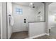 Modern bathroom with a glass enclosed shower featuring white tile and black fixtures at 25725 S 230Th St, Queen Creek, AZ 85142
