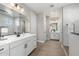 Bright bathroom with double vanity sinks, white cabinets, and a decorative backsplash at 25725 S 230Th St, Queen Creek, AZ 85142