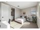 Cozy bedroom featuring a twin bed, adjacent bathroom, and a sunlit window for a warm ambiance at 25725 S 230Th St, Queen Creek, AZ 85142