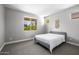 Serene bedroom with ample sunlight, soft carpeting, and pleasant outdoor views creates a calming atmosphere at 25725 S 230Th St, Queen Creek, AZ 85142