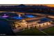 Stunning nighttime aerial view of the community area, complete with a pool and gathering spaces at 25725 S 230Th St, Queen Creek, AZ 85142