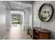 Elegant foyer with wood-look tile and a view of the back yard pool and living area at 25725 S 230Th St, Queen Creek, AZ 85142